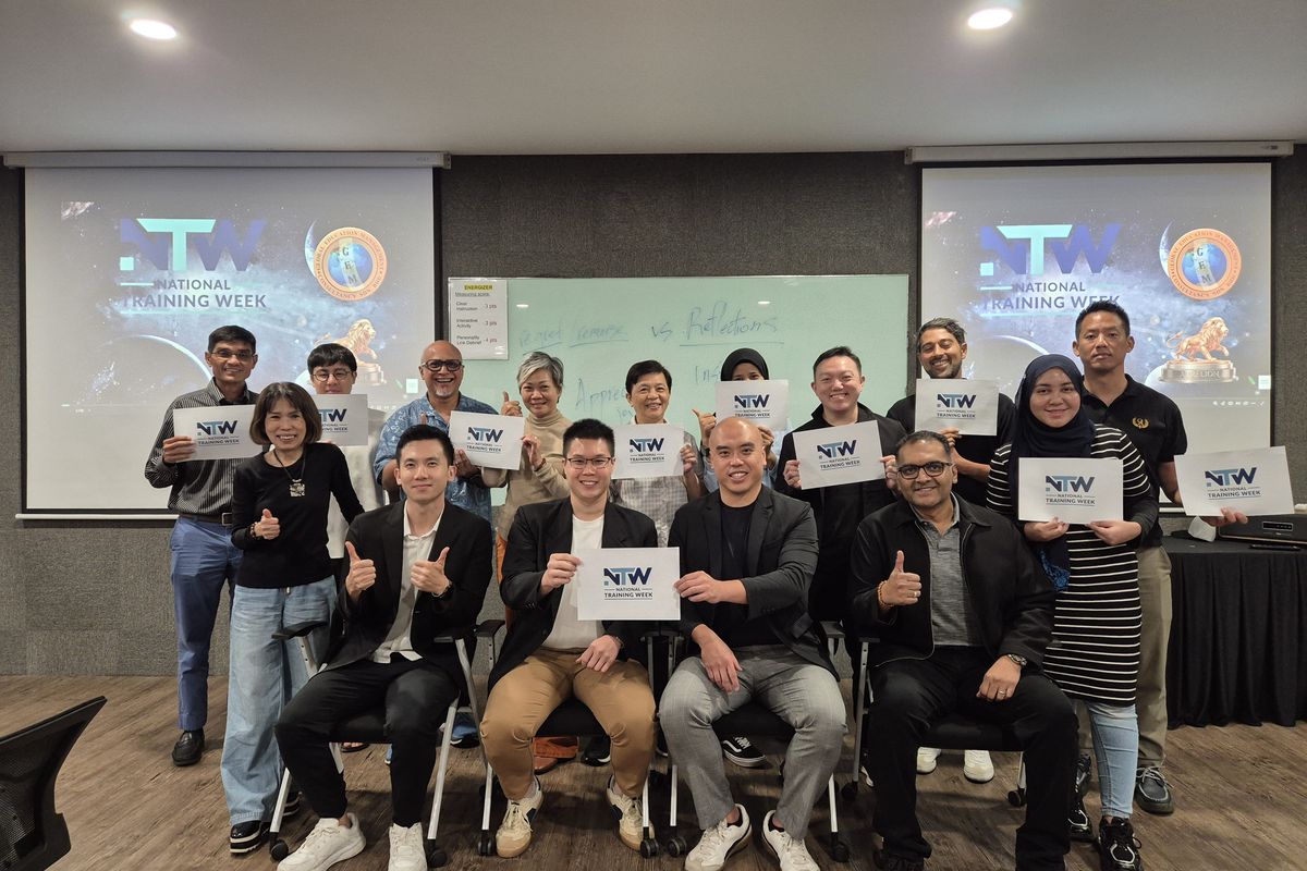A training-week group photo with thumbs up